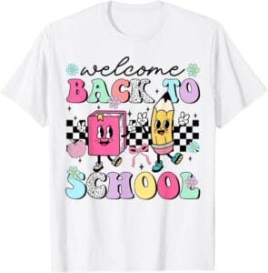 White t-shirt with a retro groovy Welcome Back To School design featuring a smiling book, a pencil, daisies and a checkerboard pattern