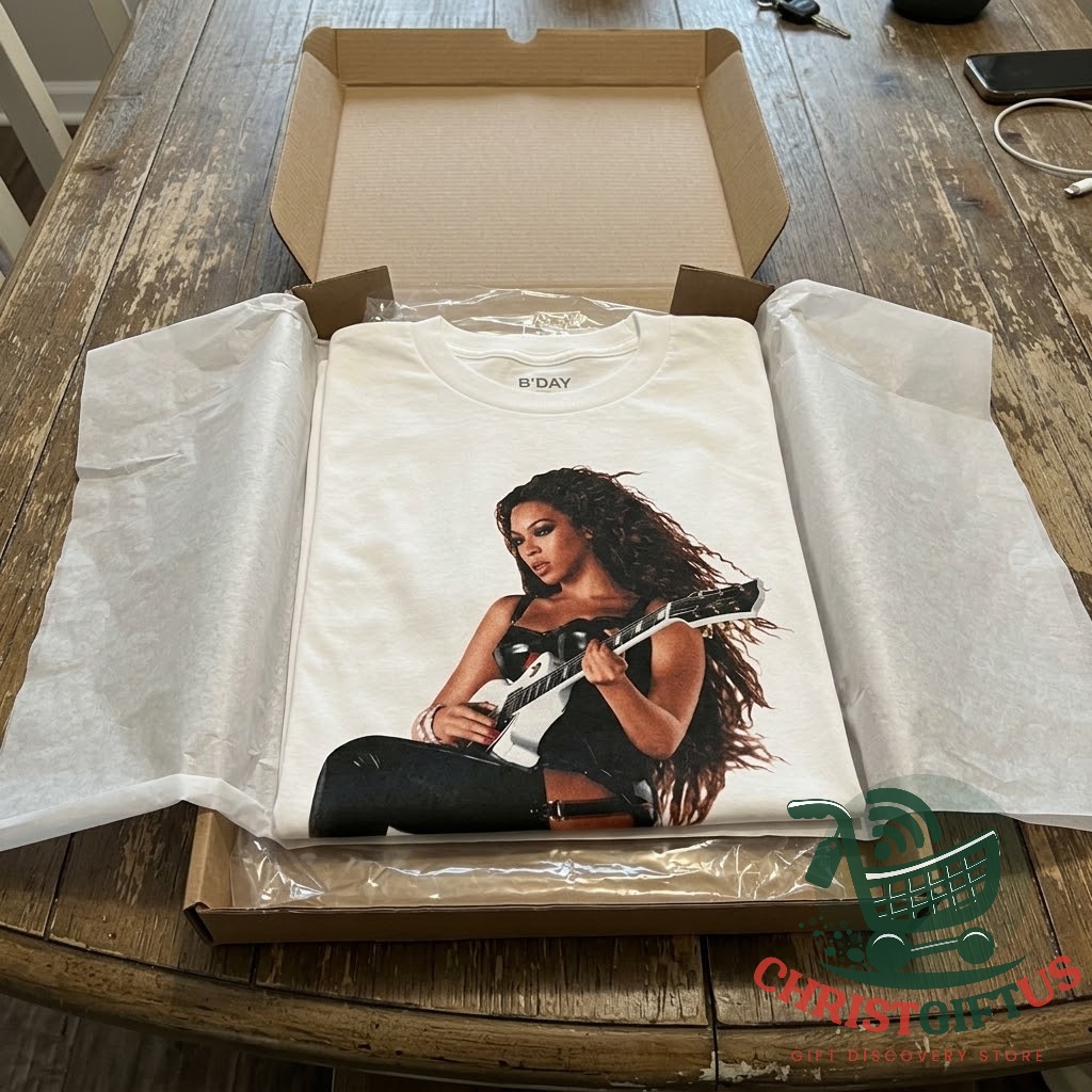 Beyoncé B'Day 20th Anniversary Album Tracklist T-Shirt 2026 – Photo 4 White T-shirt displayed against a concert stage backdrop
