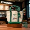 Snoopy Peanuts x Starbucks Collaboration Canvas Tote Bag - front view with green handles and character graphic